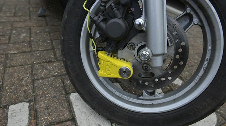 Motorcycle disc lock fitted to wheel of boke