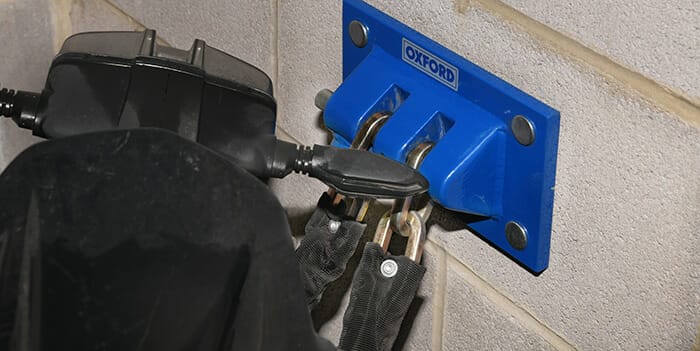 Motor Scooter with security chain fitted to ground anchor fixed to wall