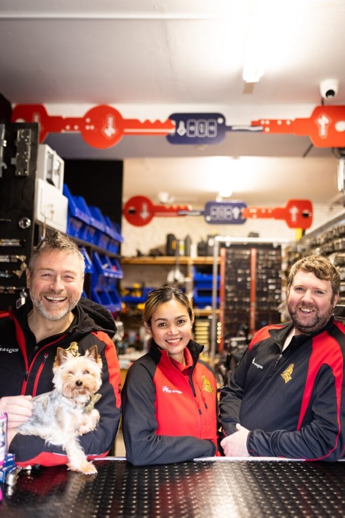 Paul Montgomery of Sir Fix A Lock, Locksmith company with dog and staff